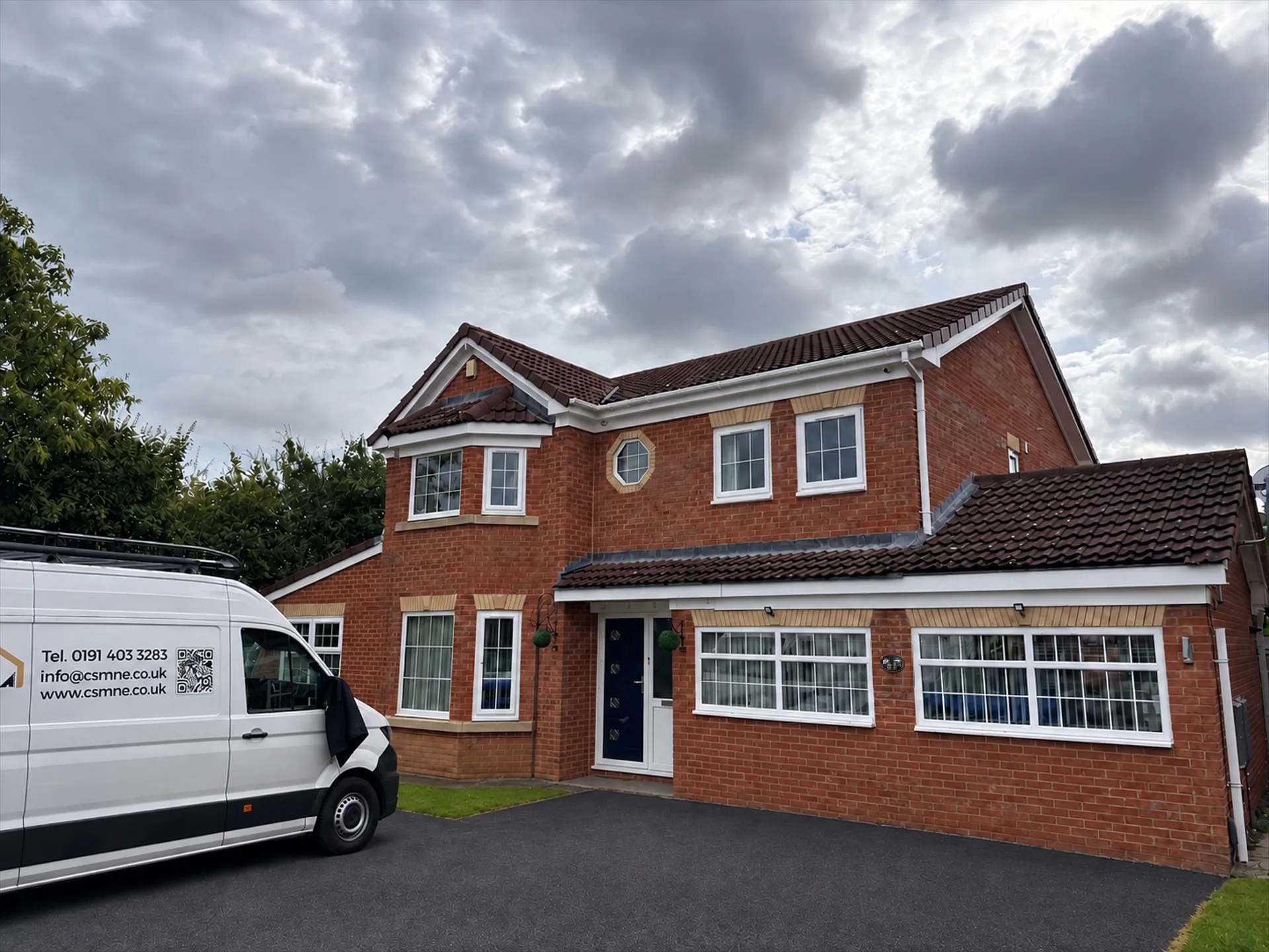 Finished front elevation in Coulby Newham showing Georgian-bar replacement windows and completed roofline work.