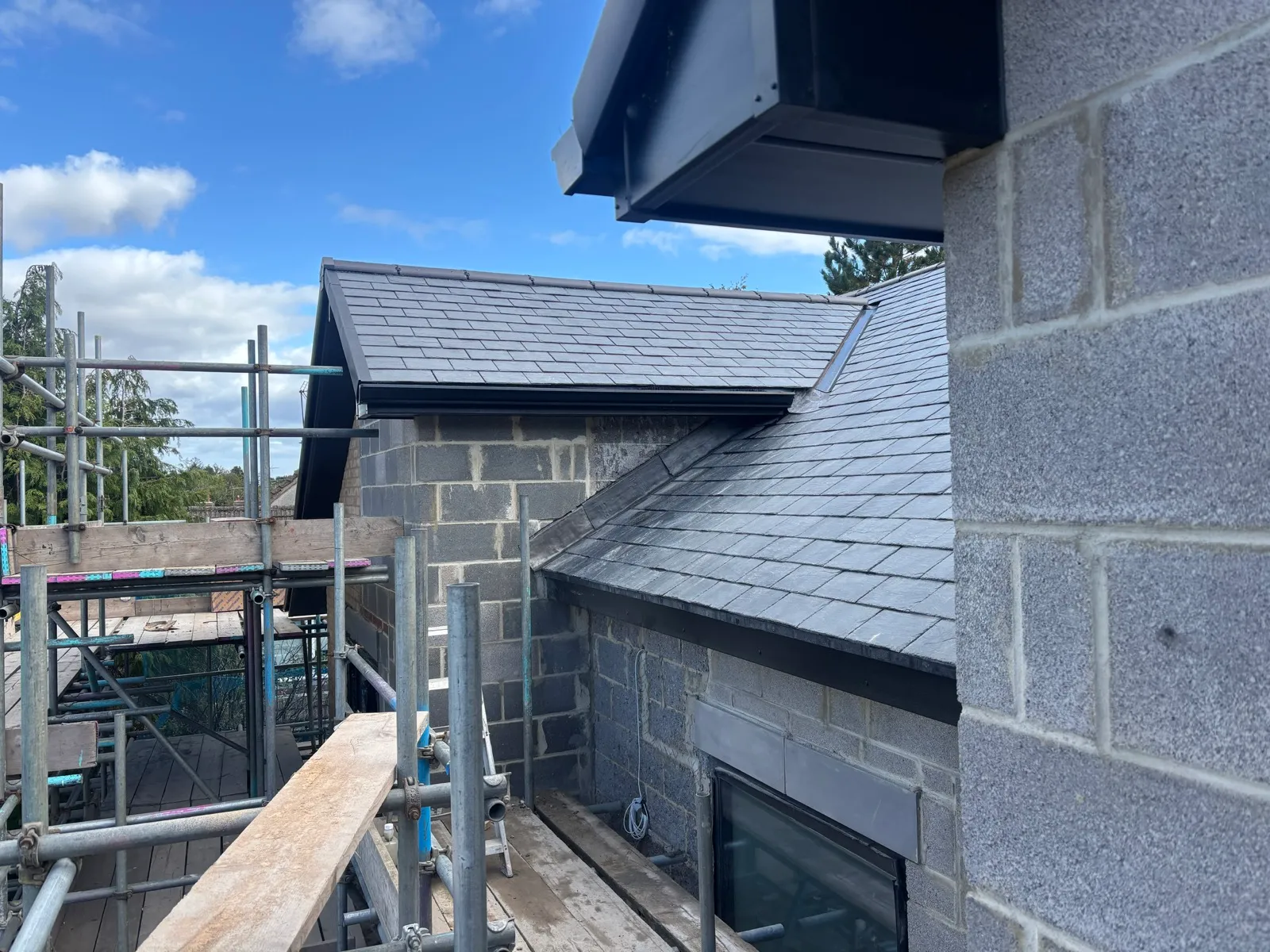 Installed guttering beside the adjoining roof sections.