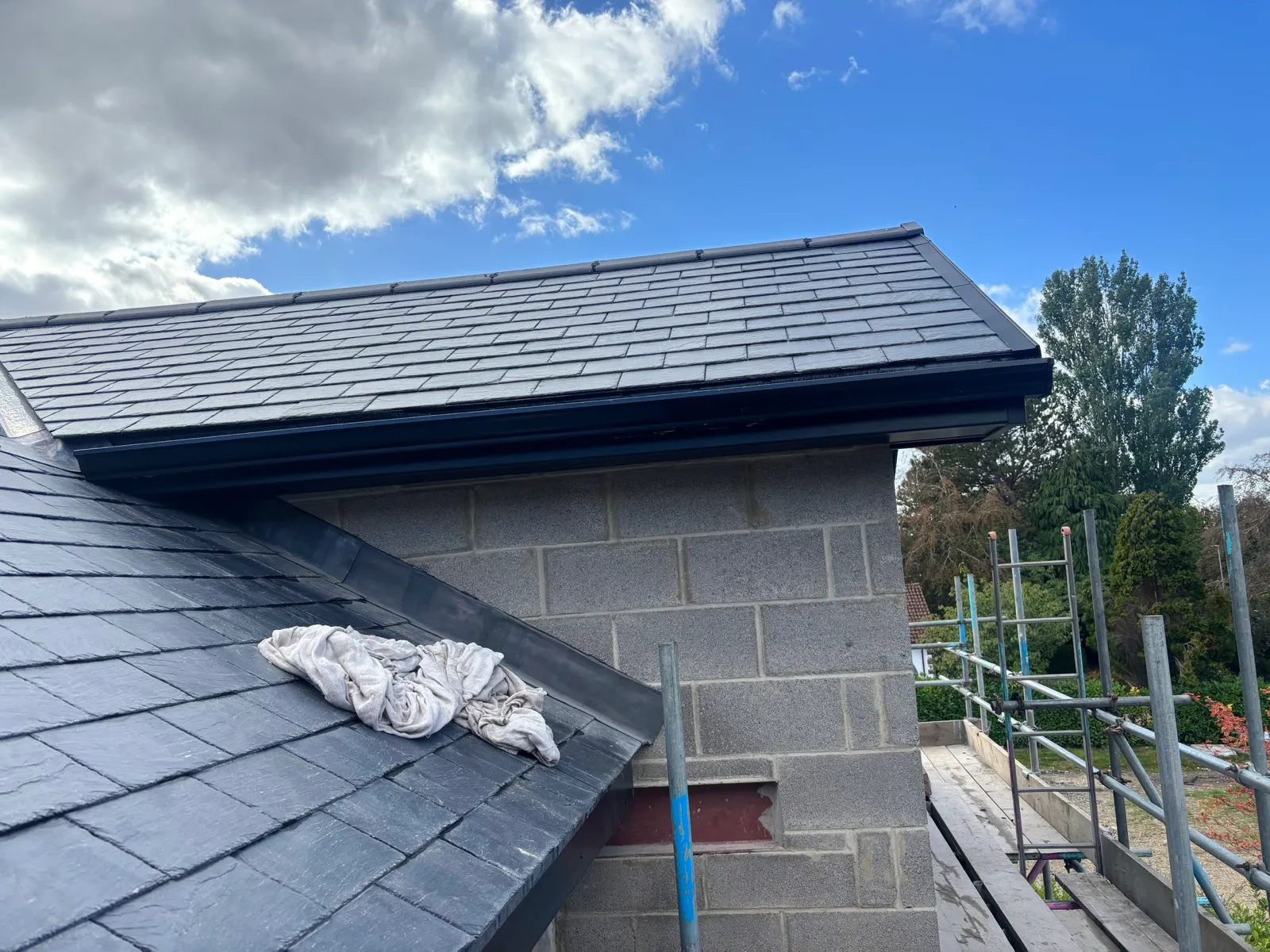 Closer view of the installed guttering below a roof section.
