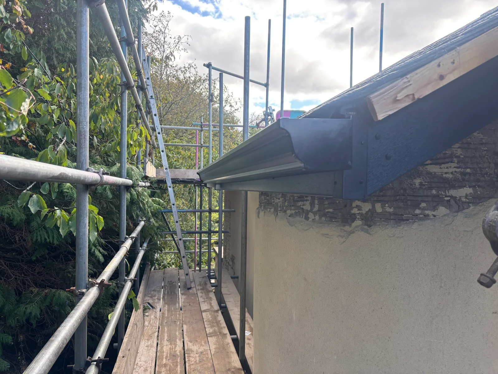 Detail of the gutter end at the roof edge.