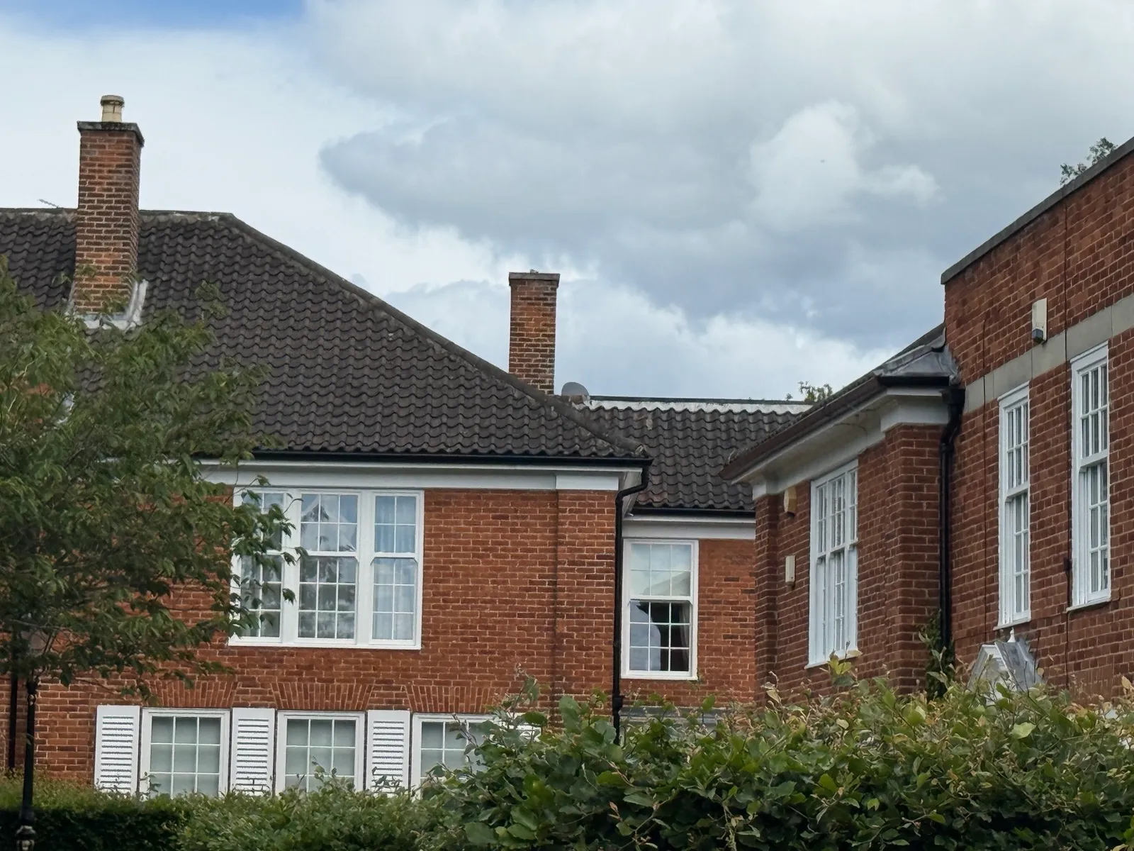 Dark guttering running along the roofline of a brick property in Gosforth.