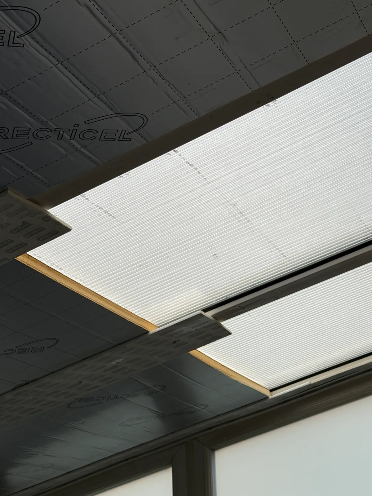 Insulation beneath the existing roof panels during opening-up.