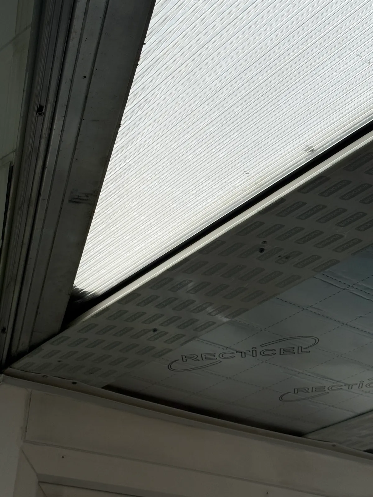 Existing roof panel, insulation and supporting bar.