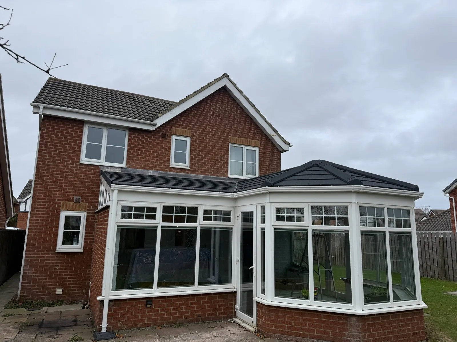 Replacement roof across the connected conservatory sections.