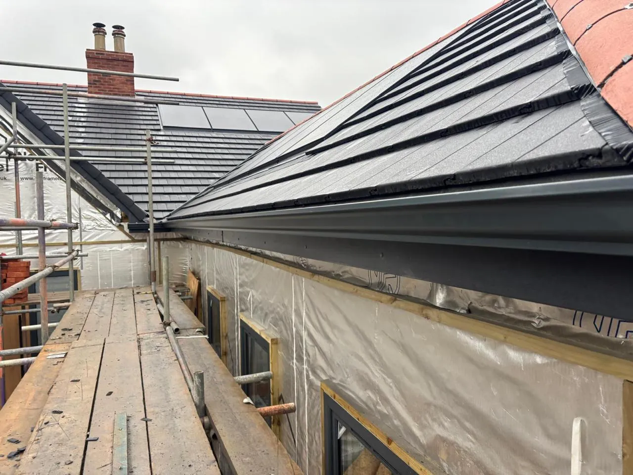 A long continuous gutter run along a tiled roof edge.