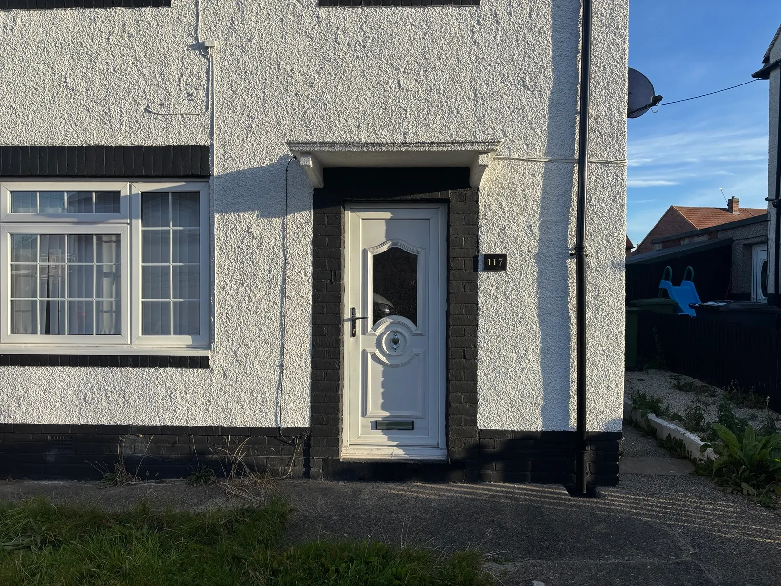 The original white uPVC front door at the South Shields property, before replacement.