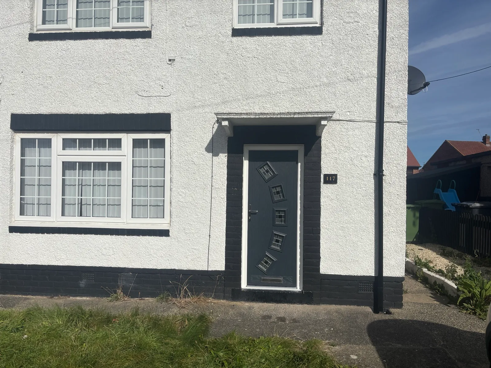 The replacement anthracite front door in South Shields, with five decorative glazed panels and a white outer frame.