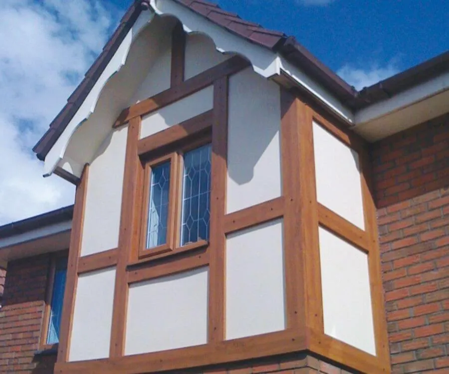 Tudor-style boards in a timber finish, shown on a gable above a bay